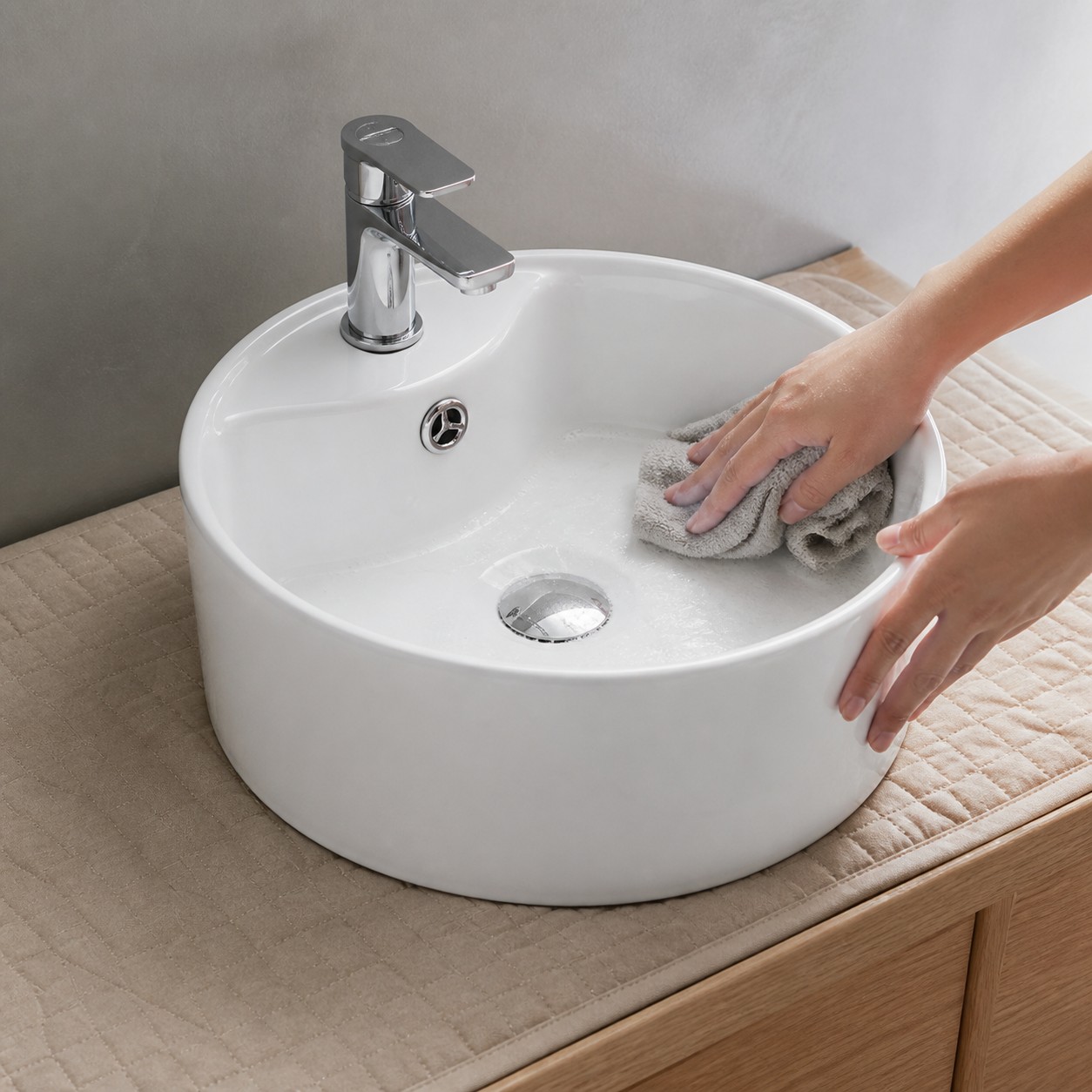 Glazed ceramic vessel sink cleaned with a soft cloth after ordinary hand washing