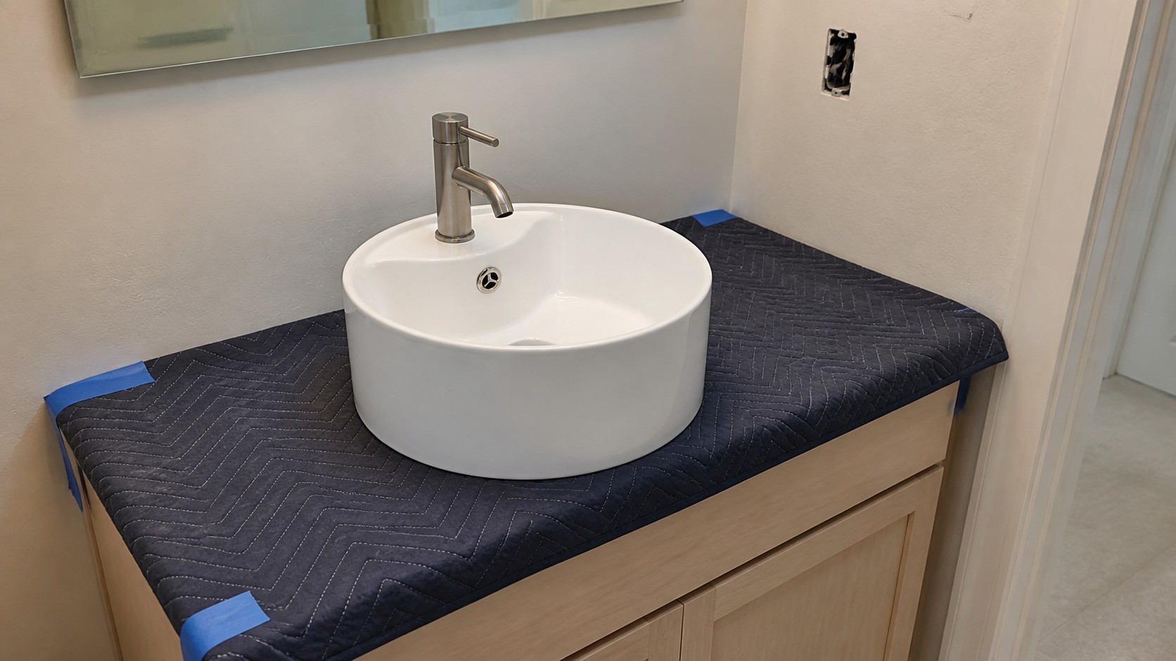 Existing bathroom vanity surveyed with a ceramic vessel sink sample before conversion
