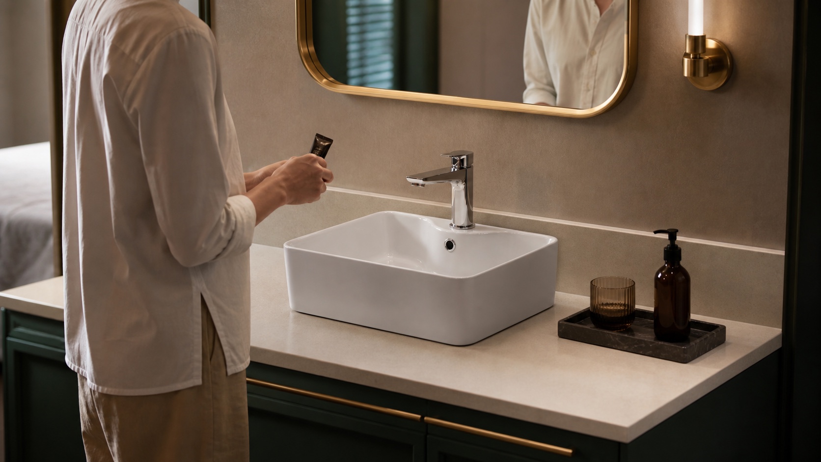 Countertop art basin with a mixer mounted through its ceramic tap hole in a hotel bathroom