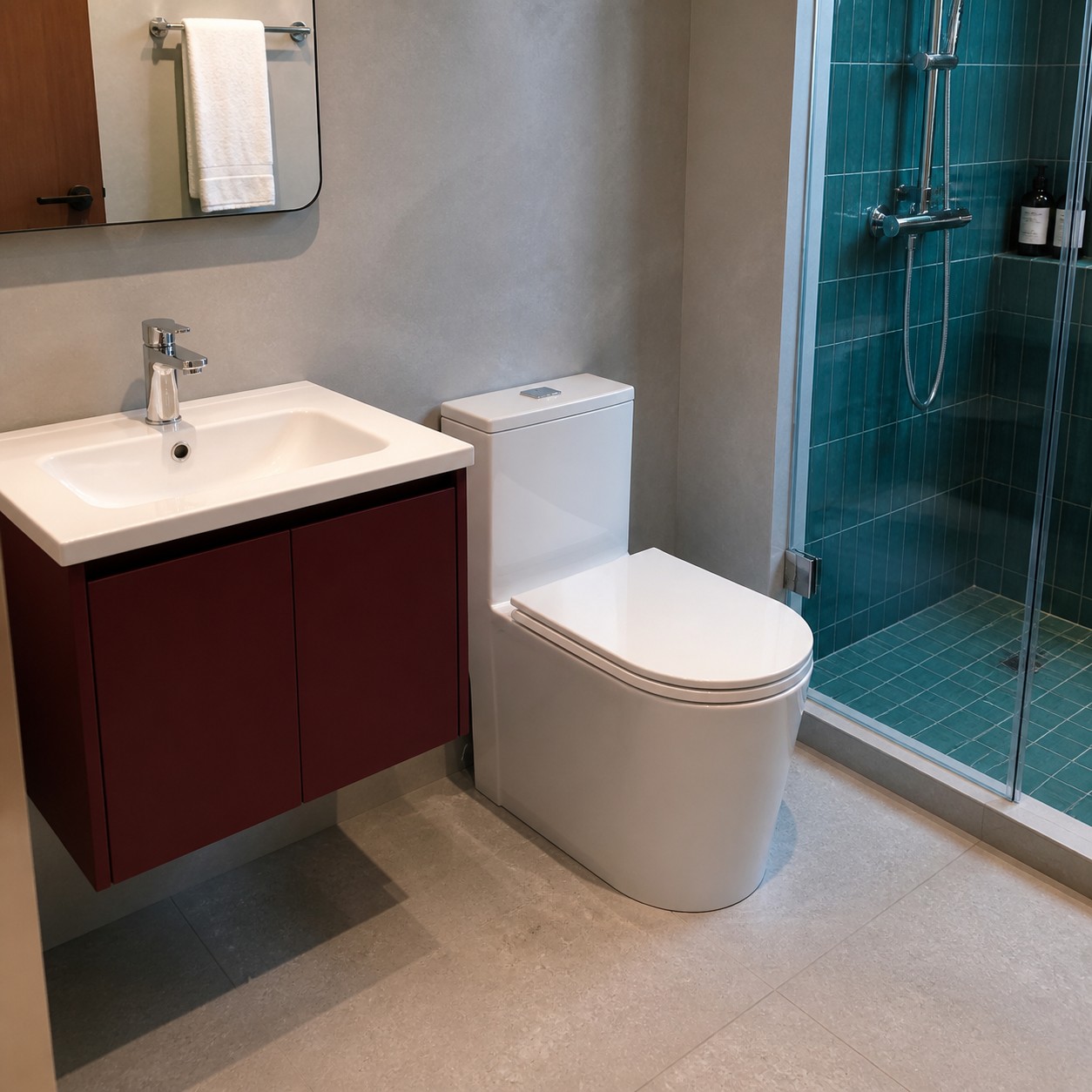 Small apartment bathroom with compact vanity toilet and corner shower
