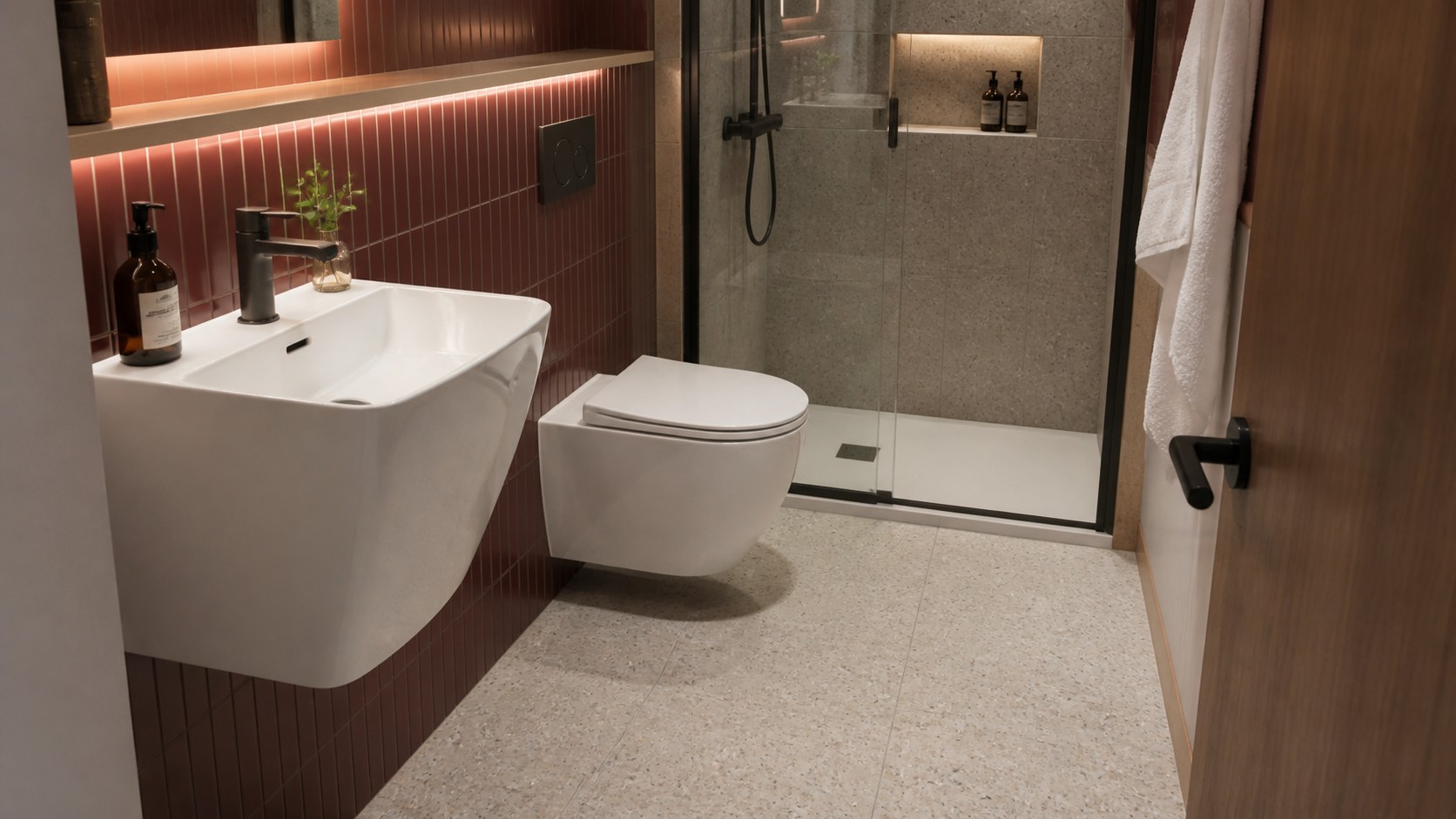 Compact hotel bathroom with a wall-hung toilet basin and shower planned around clear circulation
