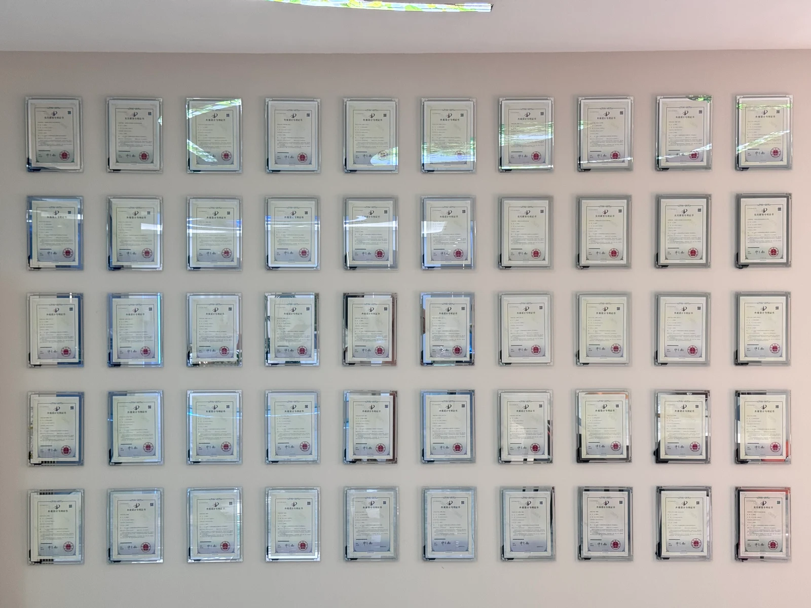 Framed certificates on the Chengda factory display wall